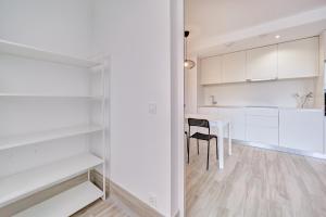 a kitchen and dining room with white cabinets and a table at Ripa by Clabao in Burlada