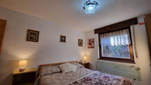 Postel nebo postele na pokoji v ubytování Il Focolare del Cermis