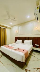 a bedroom with a large bed in a room at Shree Anantay Club & Resort in Ujjain