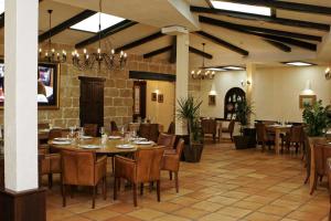 a dining room with tables and chairs in a restaurant at Meg-Lozenetz Hotel in Sofia