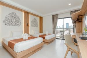 Voodi või voodid majutusasutuse Botum Domrey Hotel toas