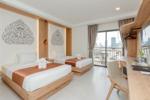 Voodi või voodid majutusasutuse Botum Domrey Hotel toas