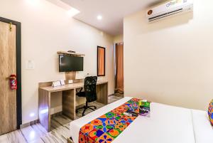 a hotel room with a bed and a desk at Glitz Hotels New United - Powai Lake in Mumbai +12 photos