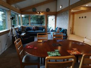 a living room with a wooden table and chairs at Nautilus Tenby in Tenby
