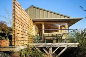 a house with a glass porch and a table at Nautilus Tenby in Tenby +9 photos