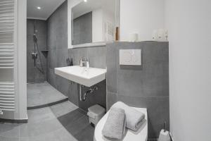 a bathroom with a sink and a toilet and a shower at Chalet La Belle Willingen in Willingen