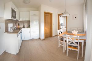 a kitchen with a table and chairs in a kitchen at Chalet La Belle Willingen in Willingen