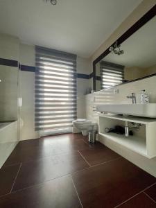 a bathroom with a toilet and a sink at Ferienappartement "Liegeplatz" in Sassnitz +10 photos