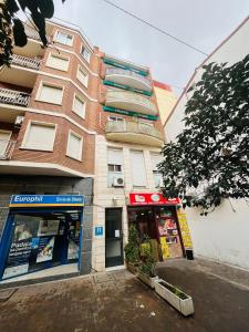 an apartment building with a store in front of it at Hostal Las Vegas in Madrid
