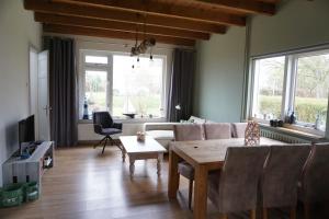 a living room with a couch and a table at Kustverhuur, Breskens, 't Zandertje in Breskens