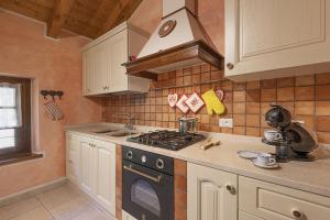 a kitchen with a stove and a stove top oven at Residenza Clarissa in Ponte di Legno +30 photos
