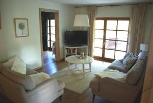 a living room with two couches and a table at Waldblick in Bleckede