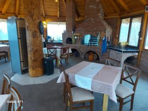 a dining room with a table and chairs and a fireplace at Legat tri brata in Ivanjica