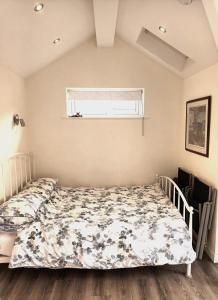 a bedroom with a bed and a window at Rose View - Modern detached bungalow in Sale +23 photos
