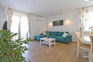 a living room with a blue couch and a table at Elegant villa with private pool in Bale in Bale