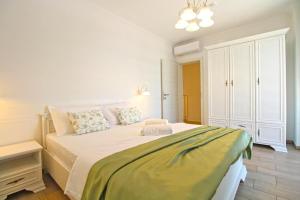 a white bedroom with a large bed in a room at Elegant villa with private pool in Bale in Bale +38 photos
