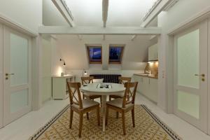 a kitchen and dining room with a table and chairs at Vila Balta Balta in Nida +27 photos