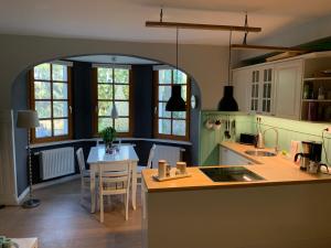 a kitchen with a table and a dining room at Seerose in Alt Wendischthun