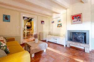 a living room with a couch and a fireplace at Typical Tuscan home in the village of Cetona in Cetona