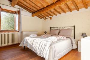 a bedroom with a large bed in a room at Typical Tuscan home in the village of Cetona in Cetona
