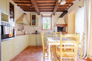 a kitchen with a table and chairs in it at Typical Tuscan home in the village of Cetona in Cetona