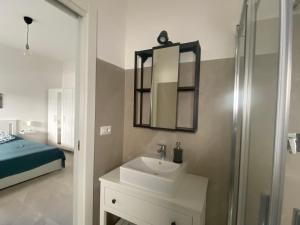 a bathroom with a sink and a mirror and a bed at il posto giusto - the right place in Anzio +19 photos