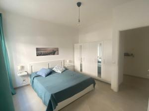 a bedroom with a bed in a white room at il posto giusto - the right place in Anzio