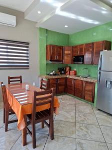 eine Küche mit Holztisch und Kühlschrank in der Unterkunft Departamentos La roca D2 in La Peñita de Jaltemba