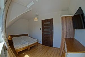 a bedroom with a bed and a large mirror at Pokoje i Restauracja Jantarowa in Jantar