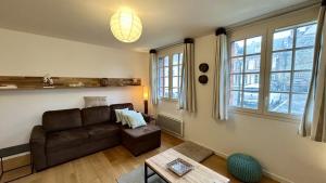 a living room with a couch and a table at La Villa Saint Germain in Saint-Valery-sur-Somme