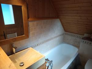 a bathroom with a bath tub and a sink at Chalet au cœur de la station in Thollon +32 photos