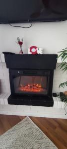 a fireplace in a living room with a fire in it at Beachside San Martin de Valdeiglecias in San Martín de Valdeiglesias