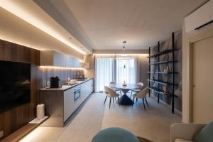 a kitchen and dining room with a table and chairs at Stemor Visionary Apartments in Desenzano del Garda