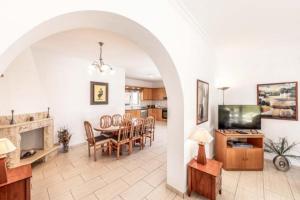 a living room with a table and a dining room at The Arches Villa in Lachi