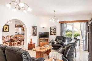 a living room with a couch and a table at The Arches Villa in Lachi