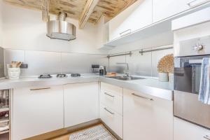 a kitchen with white cabinets and stainless steel appliances at Unconventional BnB near Linate - Supreme Meme Loft in Milan
