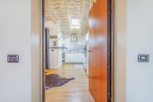 a hallway leading to a kitchen with at Unconventional BnB near Linate - Supreme Meme Loft in Milan