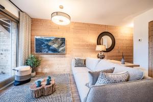 a living room with a couch and a table at Apartment Altum, Morzine - by EMERALD STAY in Morzine