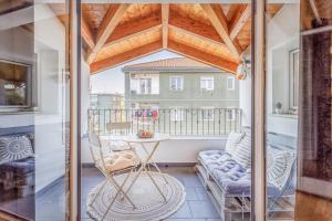 a room with a table and a chair on a balcony at Unconventional BnB near Linate - Supreme Meme Loft in Milan