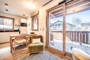 a kitchen with a desk and a table at Apartment Altum, Morzine - by EMERALD STAY in Morzine