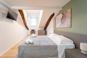 a bedroom with a bed with two towels on it at La Dimora di Barbaroux in Cuneo