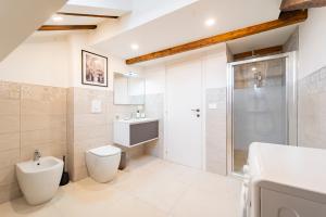 a bathroom with a toilet and a sink and a shower at La Dimora di Barbaroux in Cuneo +8 photos