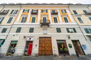a large white building with a bunch of windows at La Dimora di Barbaroux in Cuneo