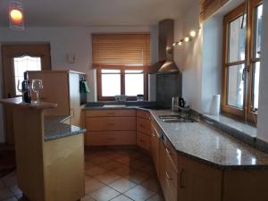 a kitchen with a sink and a refrigerator at Hahnenkammblick in Kitzbühel