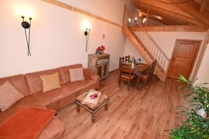 a living room with a couch and a table at Appartement Sevilla in Warnemünde