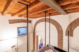 a large mirror in a room with wooden ceilings at Casa Volturno - 5 min dalla stazione in Monza