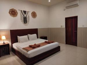 Postel nebo postele na pokoji v ubytování Wisma Bunda + 35 fotografií