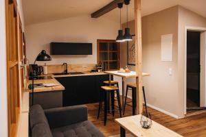 a kitchen and living room with a couch and a table at Lodge mit Sauna & Seeblick für Naturliebhaber in Diemelsee