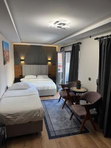 a hotel room with two beds and a table and chairs at SkyLife OldCity Hotel in Istanbul +46 photos