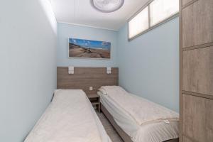 a bedroom with two beds and a window at Appartementencomplex Juliana 148 in De Koog +3 photos